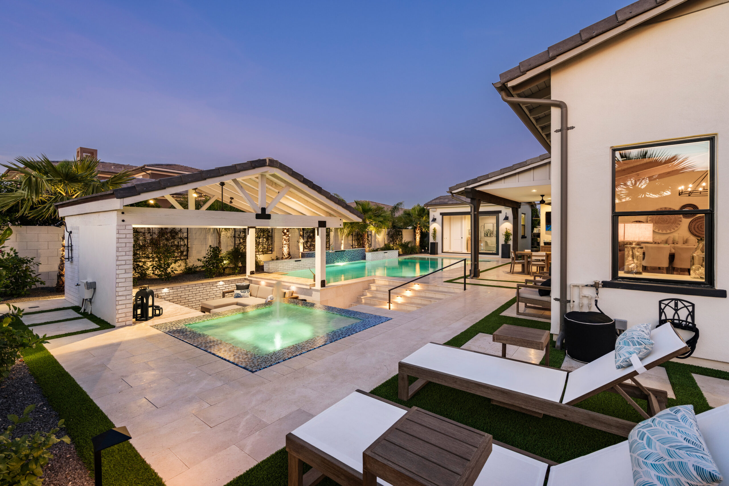 a pool and a house with a hot tub