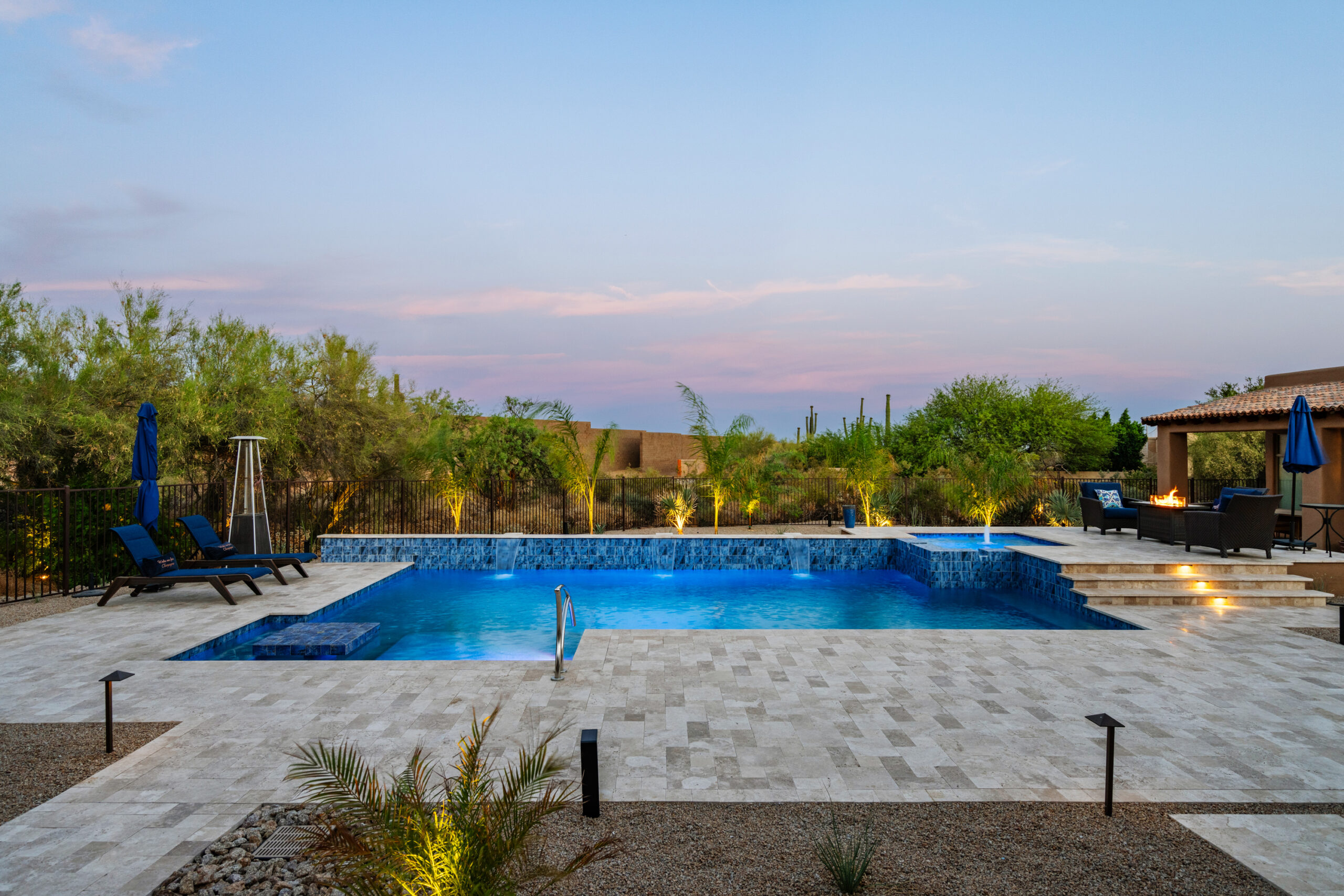 a pool with chairs and trees