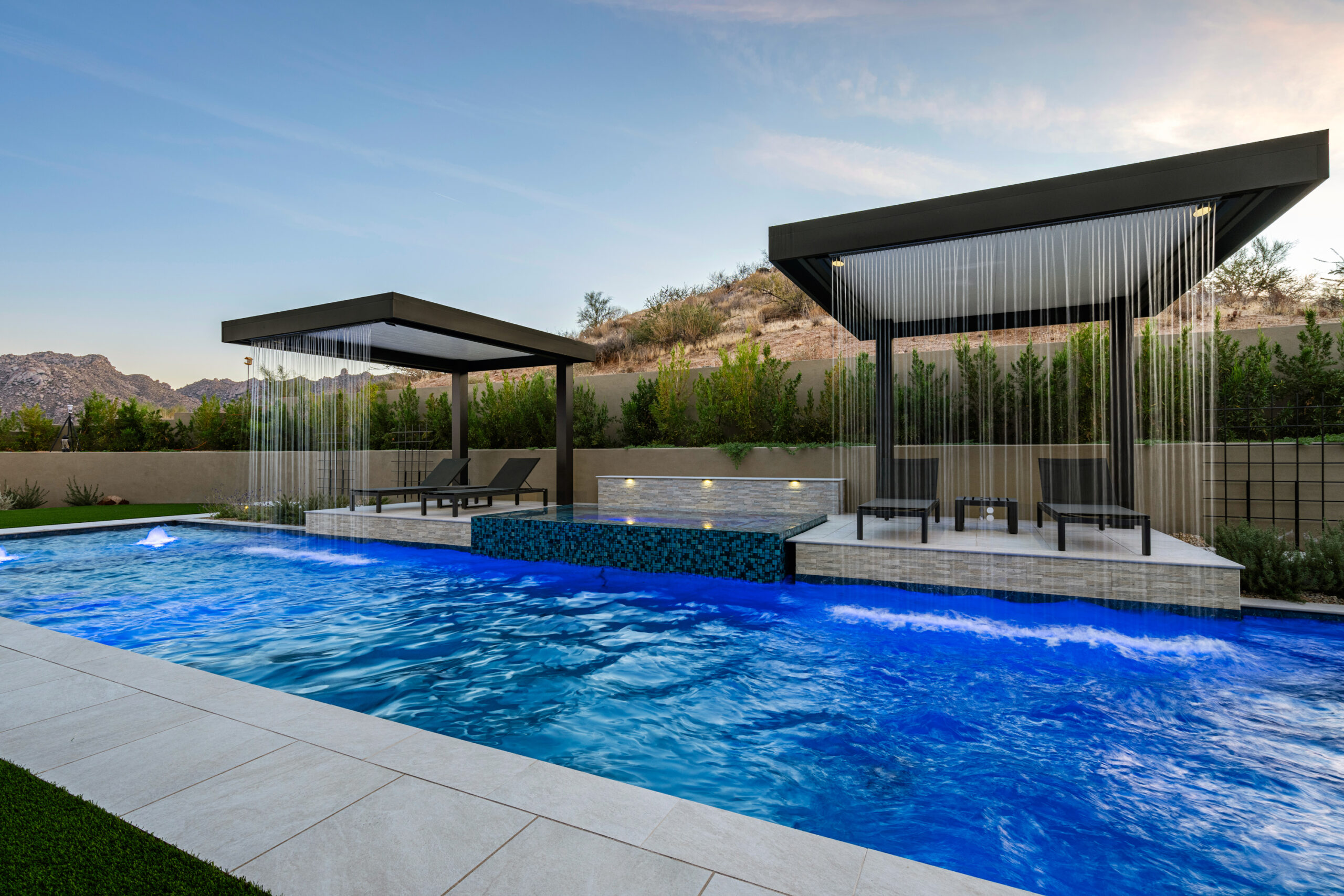 a pool with a waterfall over it