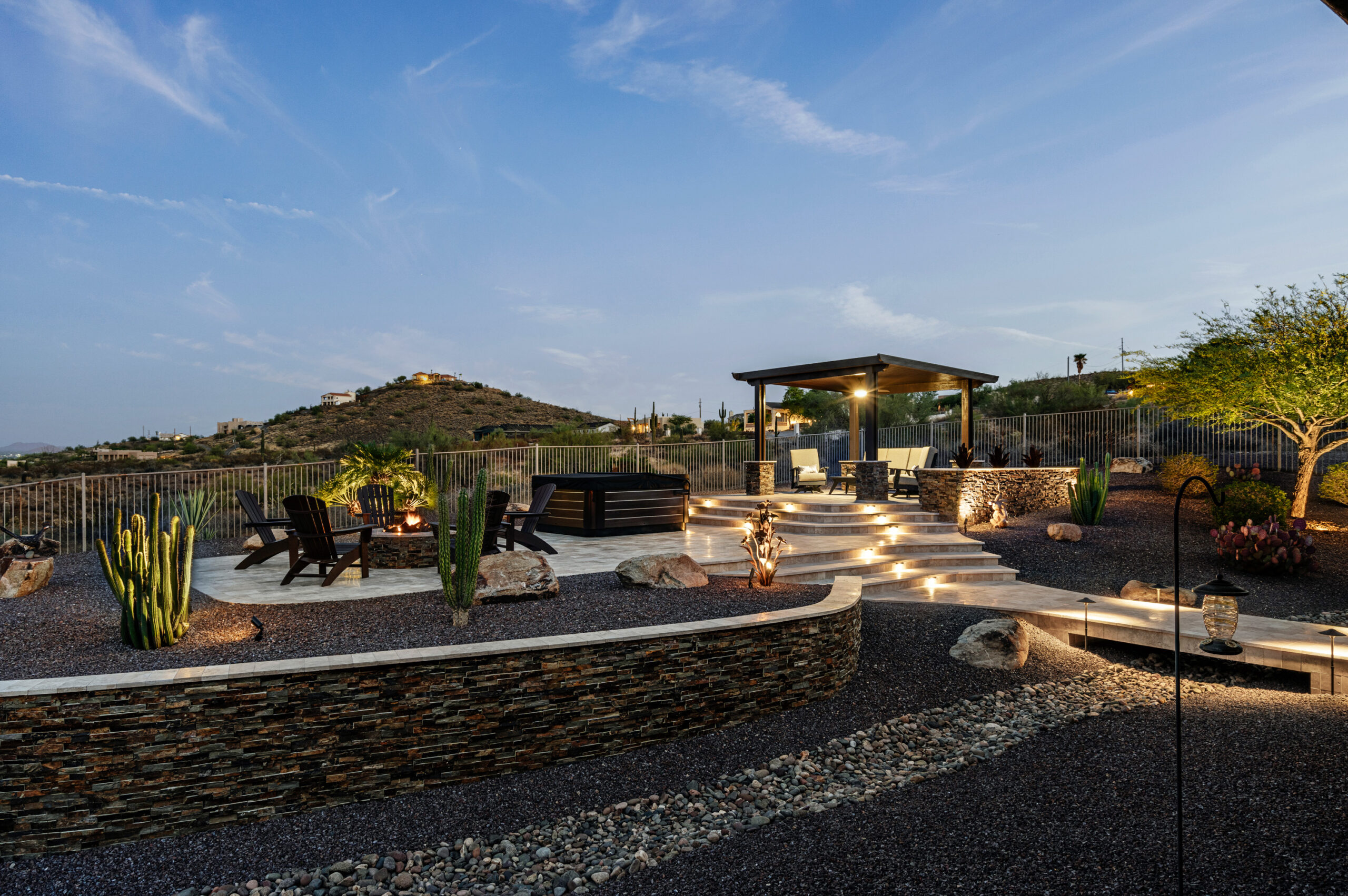 a patio with a fire pit and a gazebo