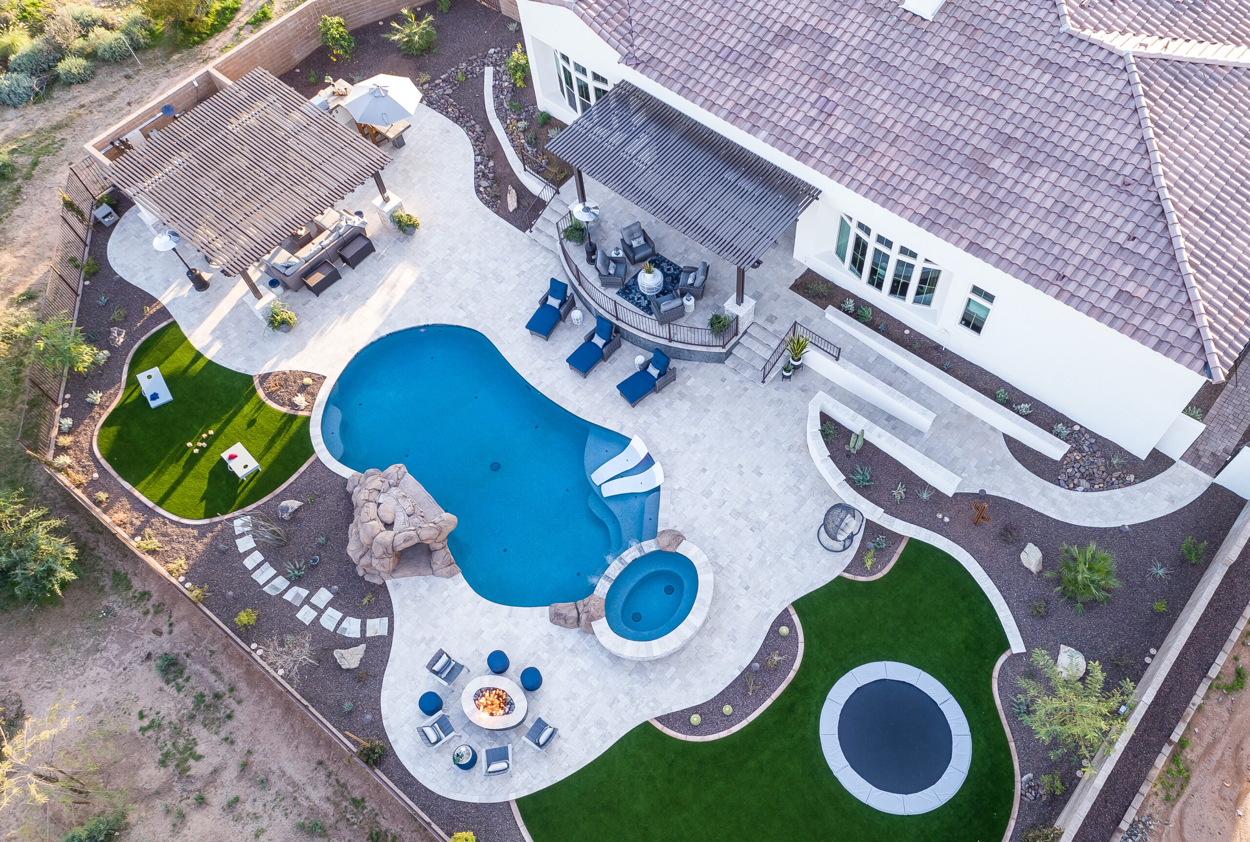 a pool and a fire pit in a backyard