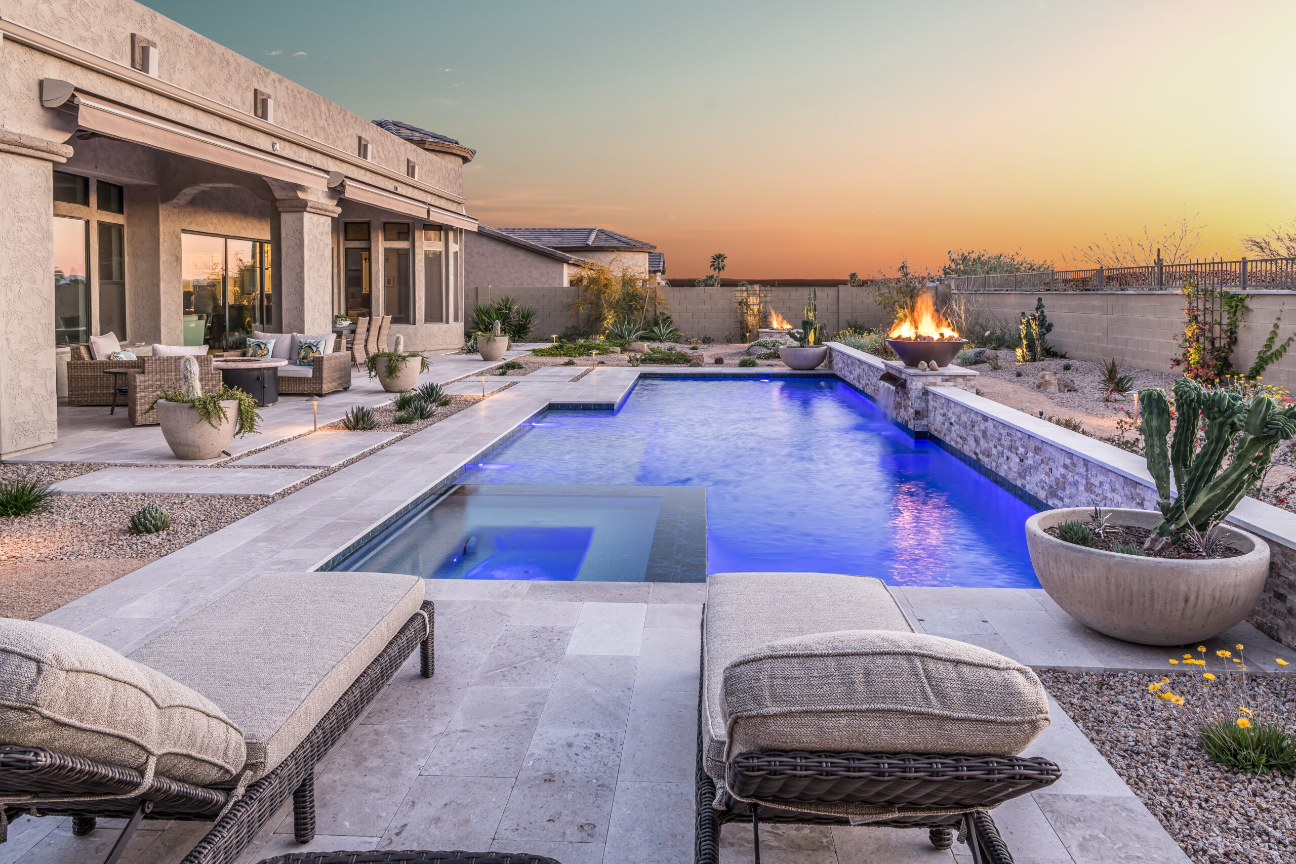 a pool with a fire pit and chairs