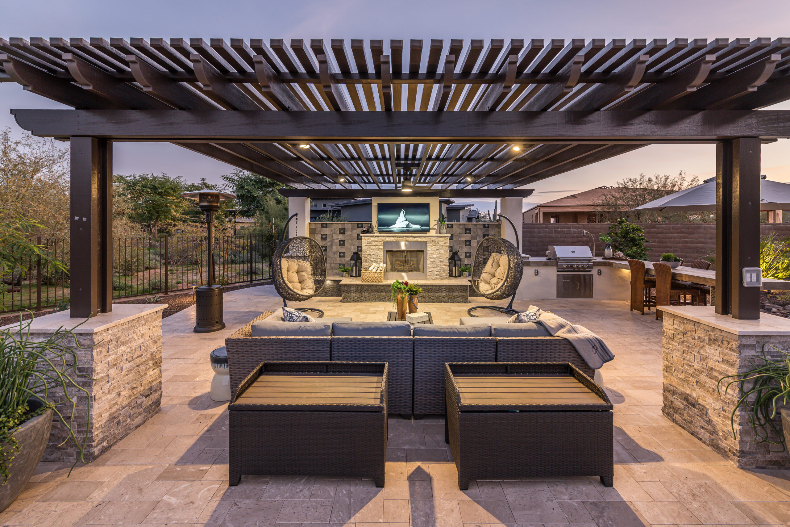 a patio with a covered patio and a fireplace
