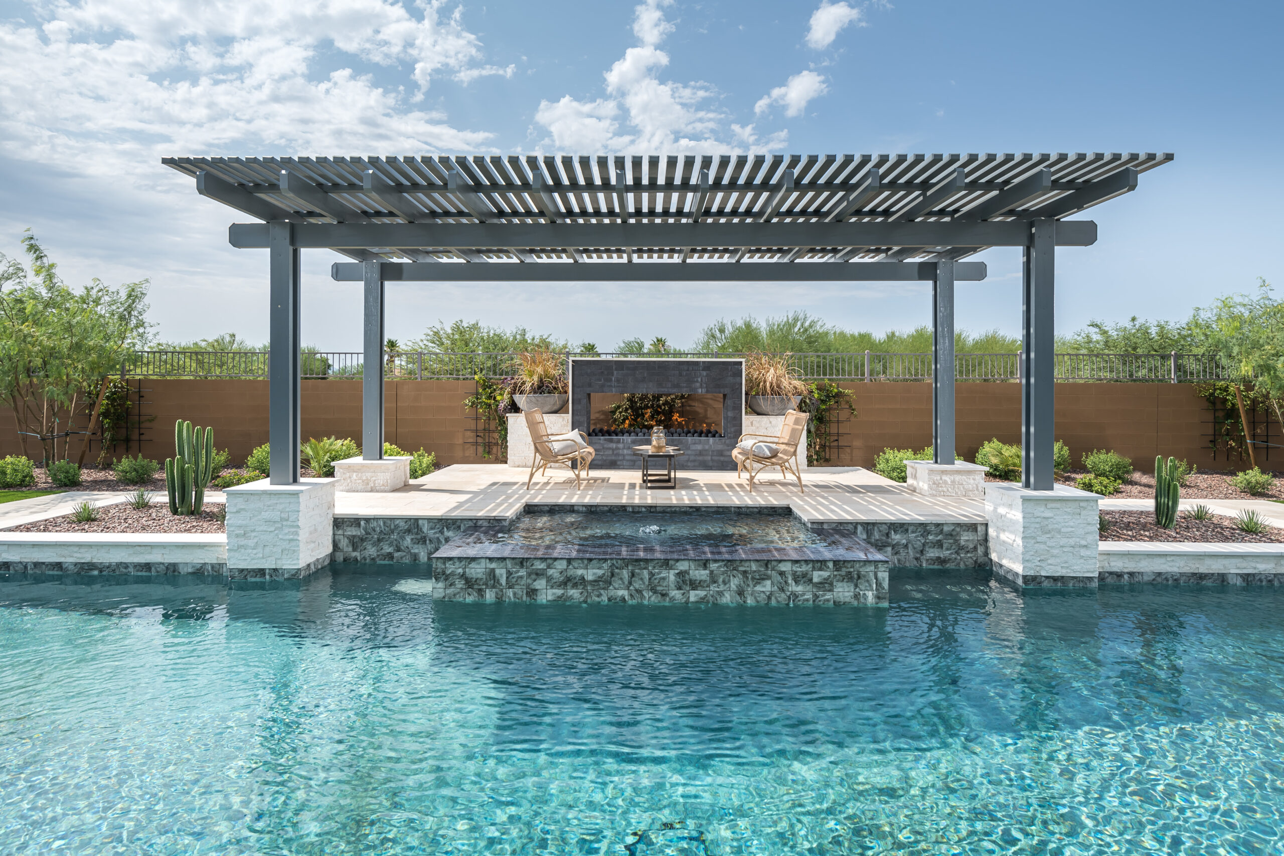 a pool with a covered patio and a fireplace