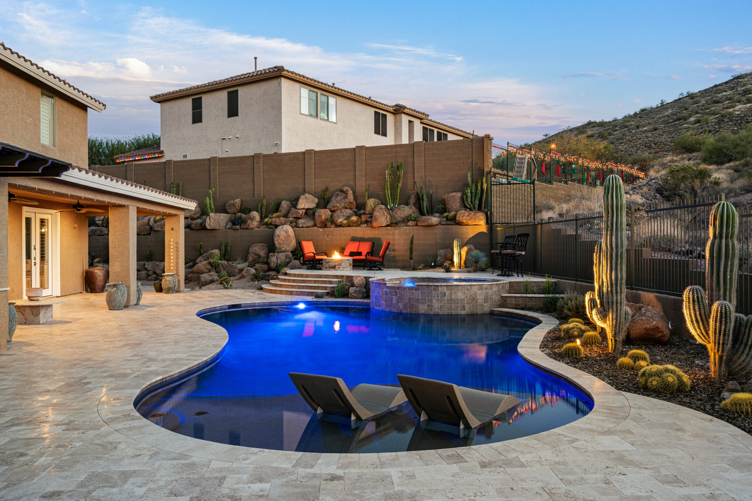 a pool with a pool and cactus in the back