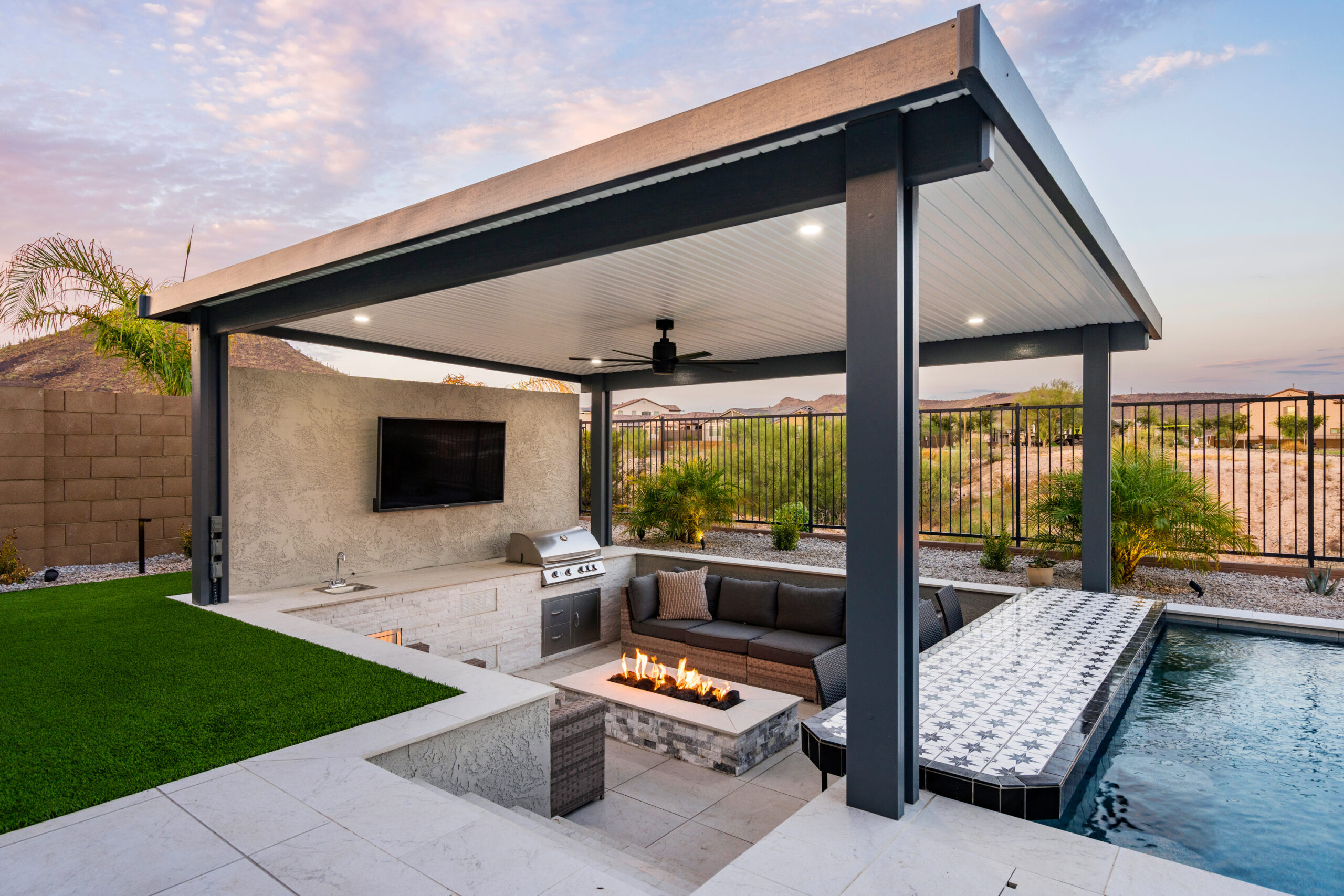 a patio with a fire pit and a fireplace