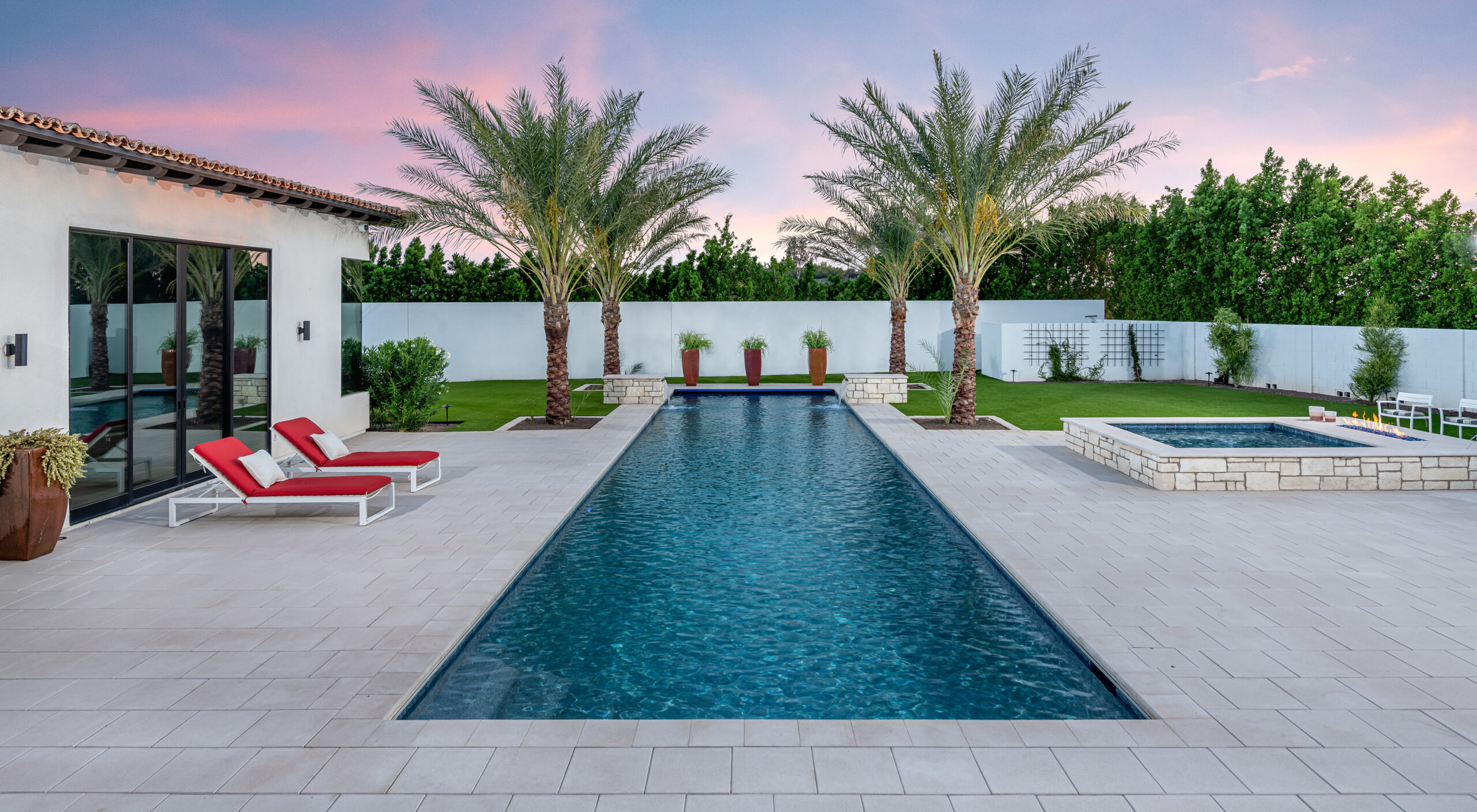 a pool with palm trees and a building
